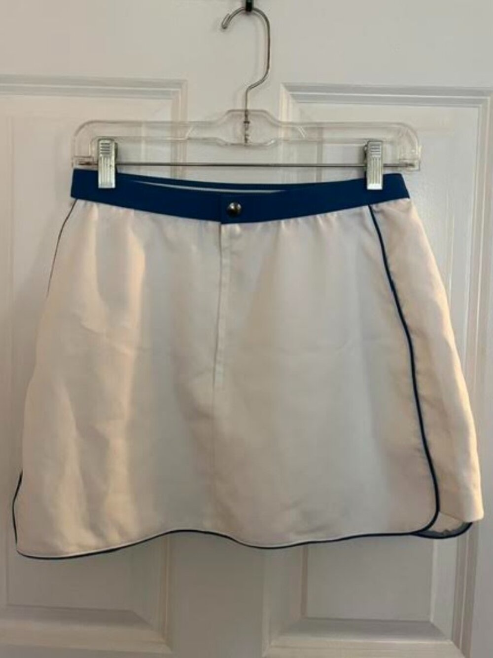 Tennis/golf skirt, short white, polyester rayon, royal blue trim